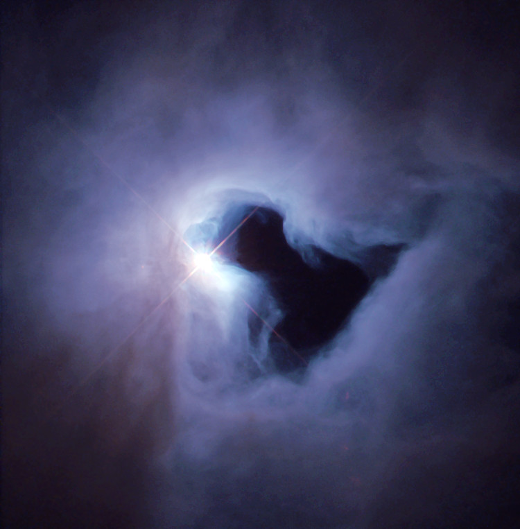 NGC 1999, also known as The Cosmic Keyhole, is a dust-filled bright nebula with a vast hole of empty space represented by a black patch of sky, as can be seen in the photograph. It is a reflection nebula, and shines from the light of the variable star V380 Orionis.